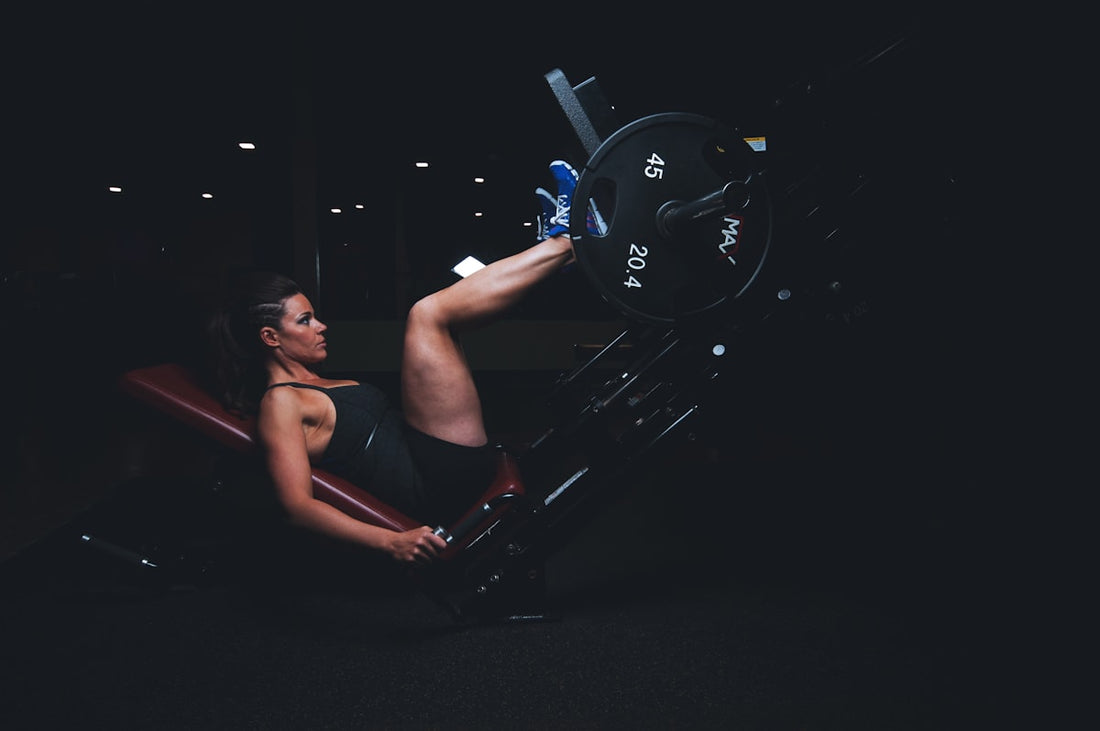 Female athlete performing powerful leg press exercise demonstrating strength training